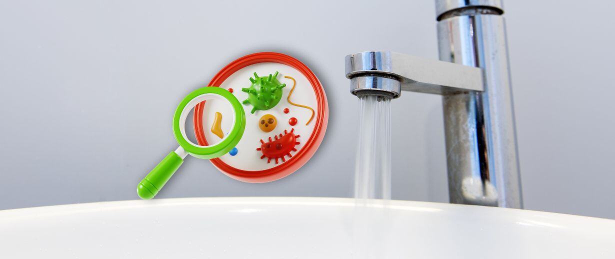 A chrome tap running water into a white basin with a graphic of a magnifying glass highlighting pathogens to the right